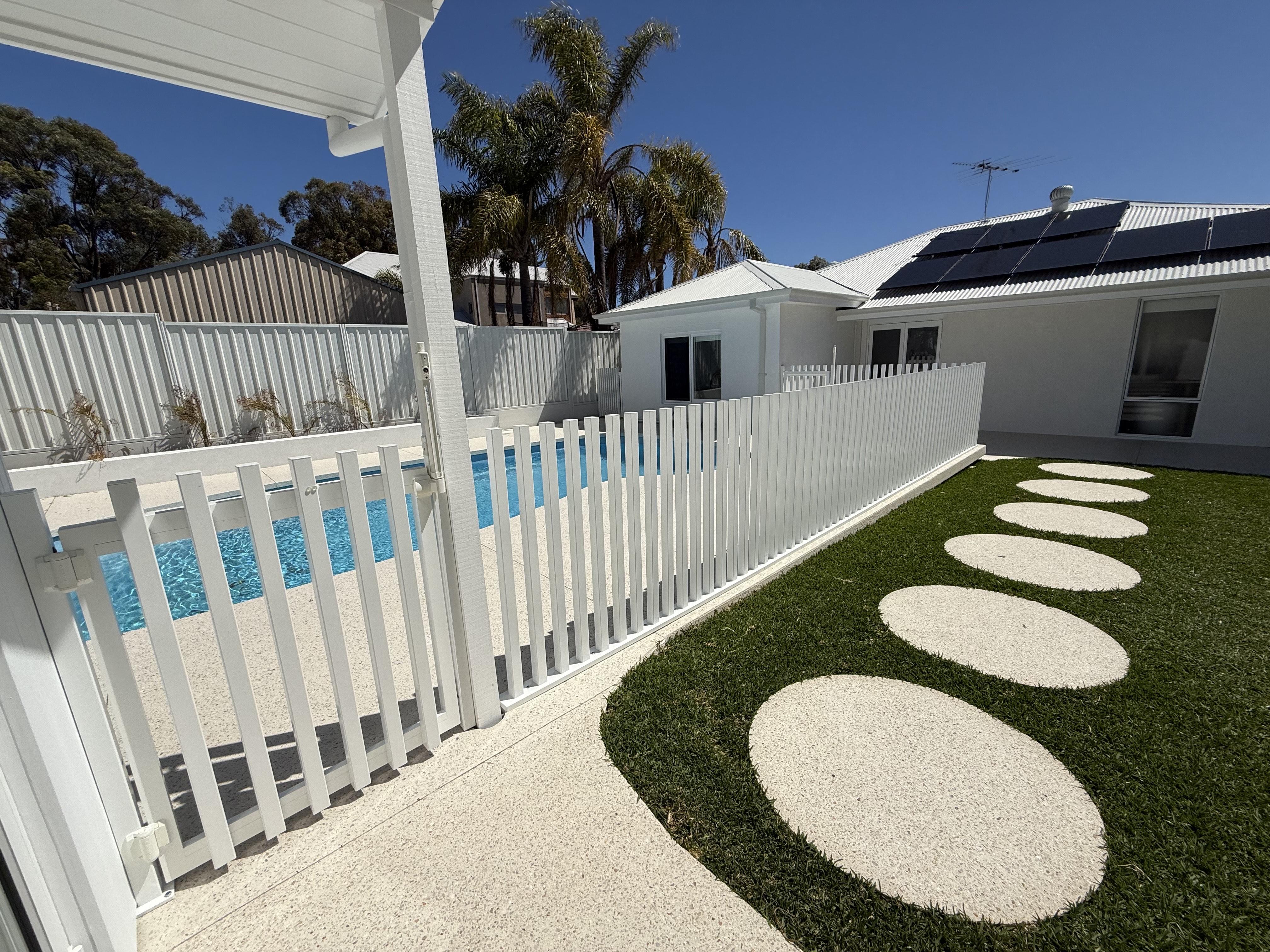 White SquareLine pool fence with stepping stones